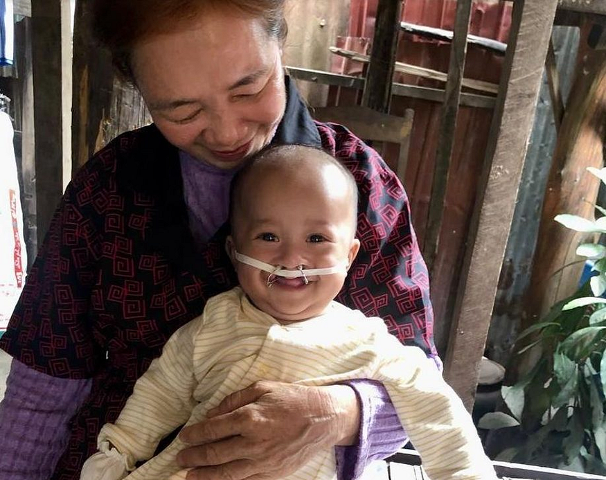 Baby Chann with foster mother Chheng Ry in the Siem Reap province of Cambodia, where Family Care First, a USAID-funded network of organizations, assists Cambodian children to live in safe, nurturing family-based care. Family Care First