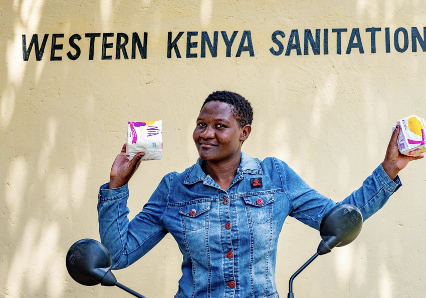 One of the boda girls showing off the menstrual hygiene products she keeps stocked for her female customers. 